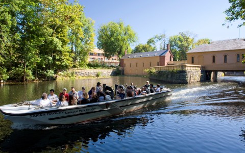 River Boat with people on it taking a tour